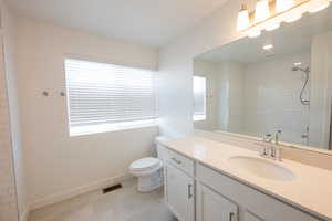 Bathroom with vanity and light tile patterned flooring