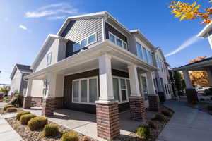 View of front of home featuring a porch and brick siding