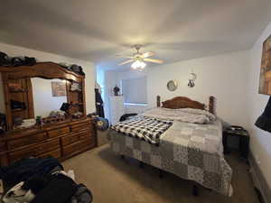 Carpeted bedroom with ceiling fan