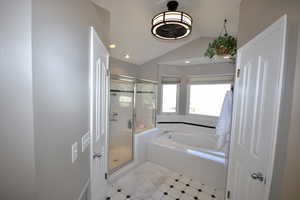 Primary Full bathroom with a shower stall, lofted ceiling, a garden tub, and recessed lighting