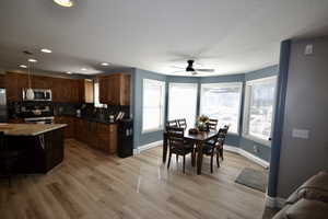 Dining area featuring ceiling fan, recessed lighting, a textured ceiling, light wood finished floors, and a baseboard radiator