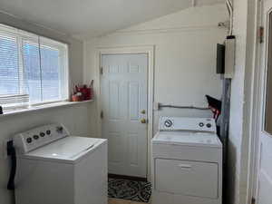 Laundry area featuring washing machine and dryer and lofted ceiling