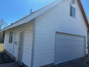 View of side of property with a garage