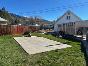 Fenced backyard with a patio and a mountain view