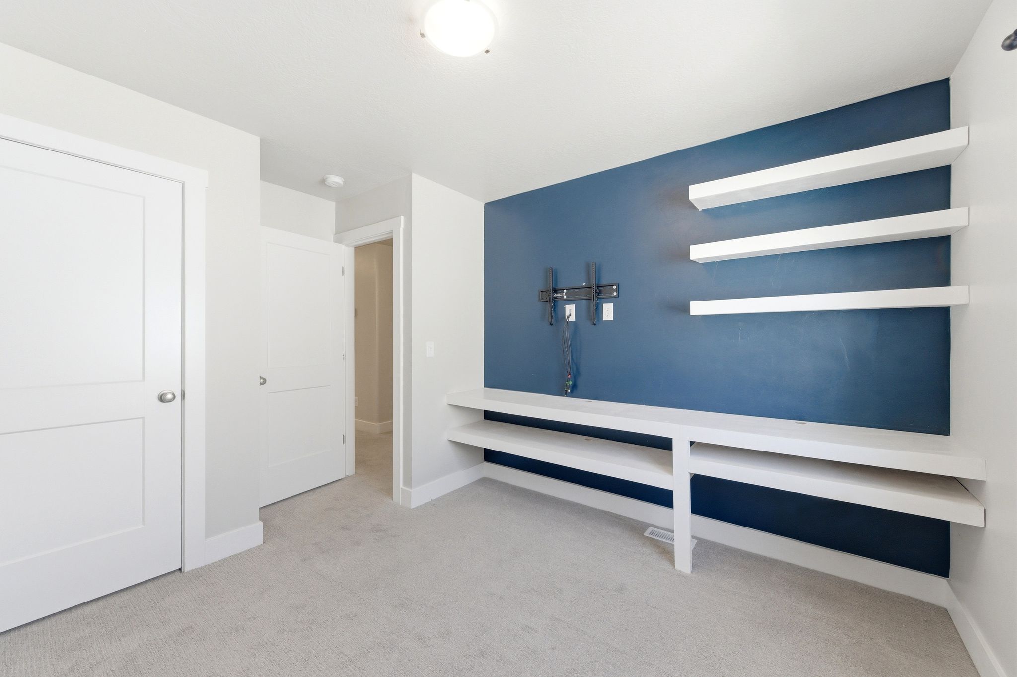 Interior space with light colored carpet and baseboards