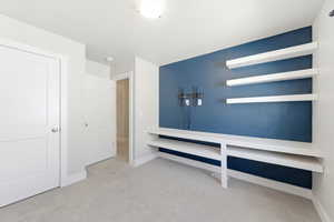 Interior space with light colored carpet and baseboards