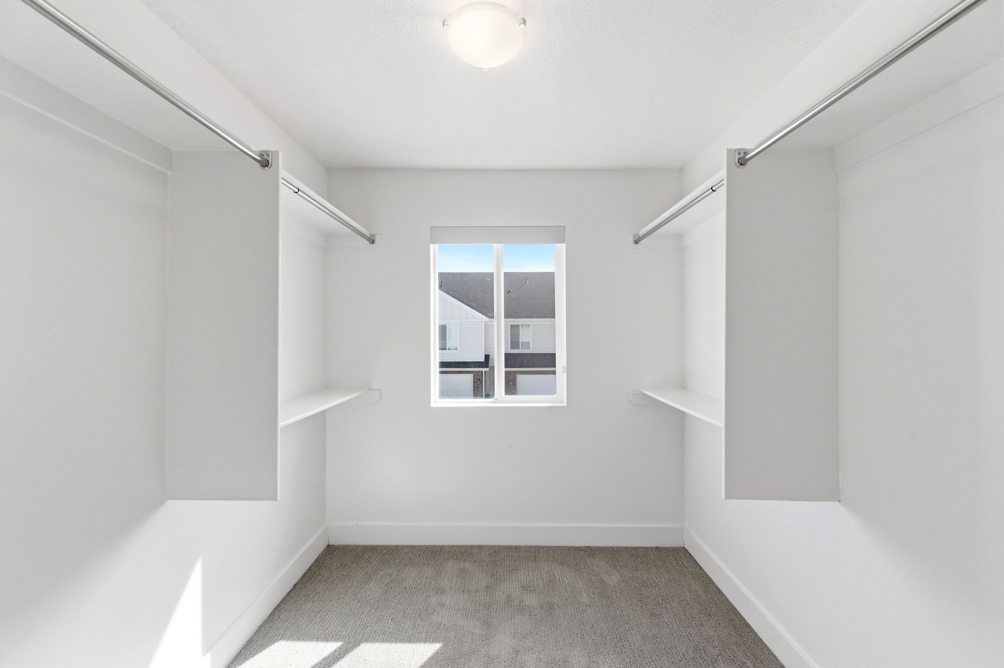 Walk in closet with light carpet