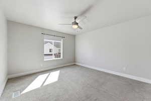 Unfurnished room featuring light carpet and a ceiling fan