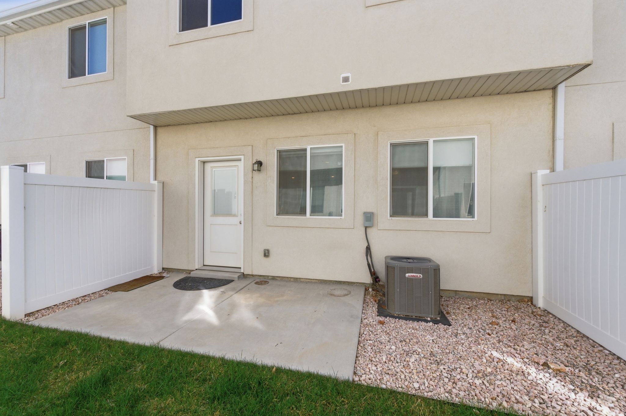 Property entrance with stucco siding and a patio