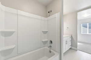 Bathroom featuring vanity and shower / tub combination