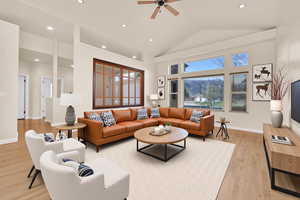 Living room with recessed lighting, ceiling fan, healthy amount of natural light, light wood-style floors, and lofted ceiling