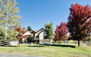 View of front of home featuring stone siding and stucco siding