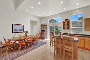 Dining room with light wood-style floors and recessed lighting