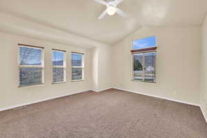 Empty room featuring ceiling fan and carpet flooring