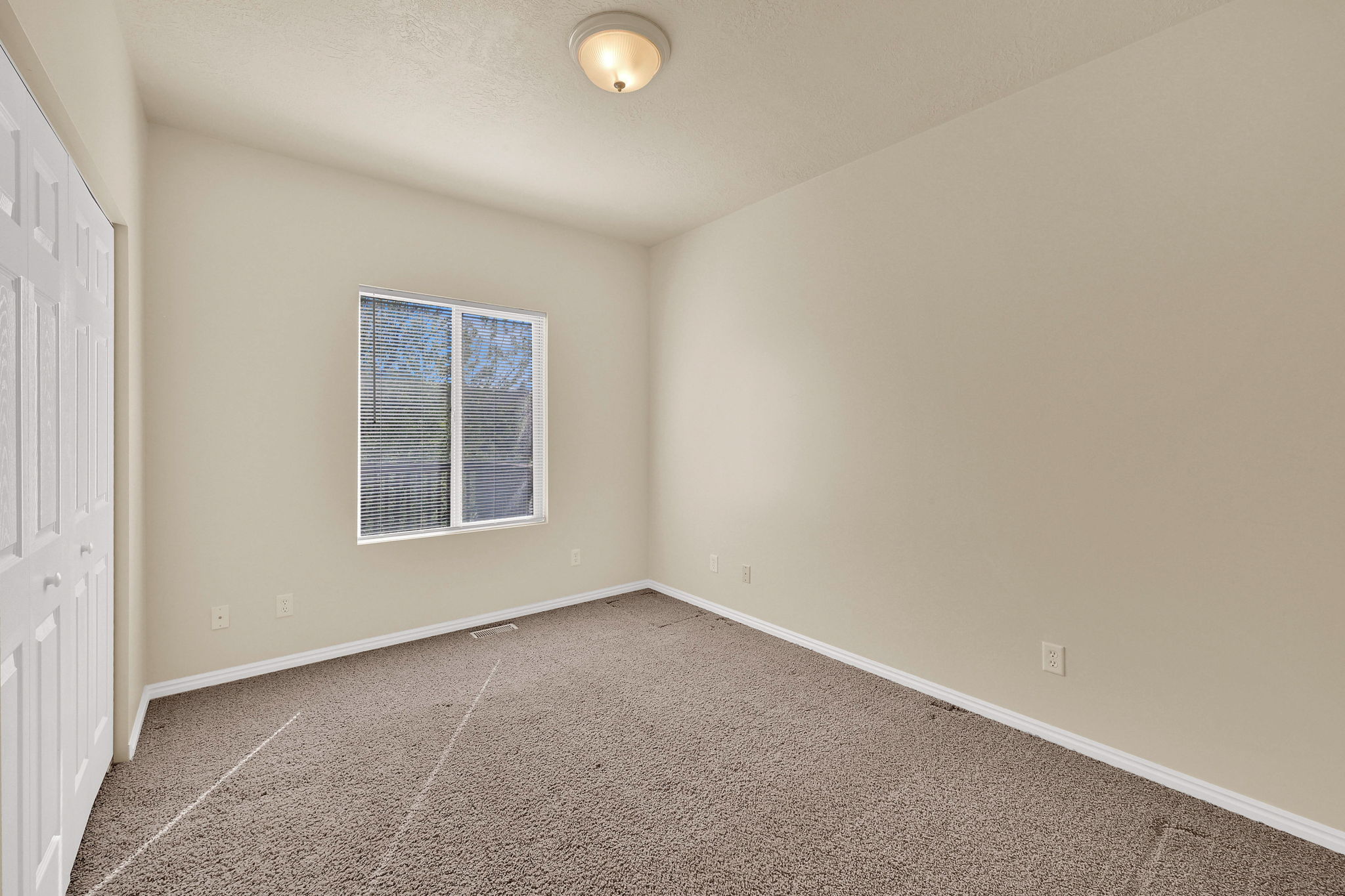 Unfurnished bedroom with a closet and carpet floors