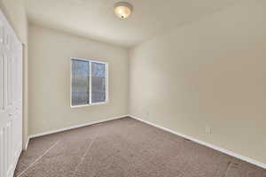 Unfurnished bedroom with a closet and carpet floors
