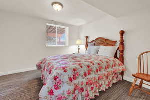 Carpeted bedroom featuring baseboards