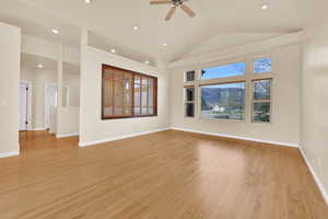 Unfurnished room featuring light wood finished floors, recessed lighting, a ceiling fan, and vaulted ceiling