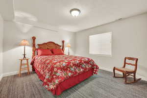 Carpeted bedroom with baseboards