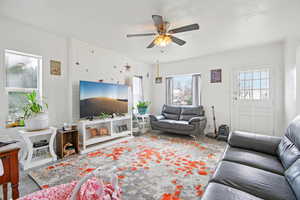 Living room with wood finished floors and a ceiling fan