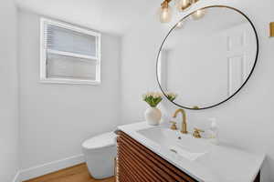 Bathroom featuring vanity and light wood finished floors