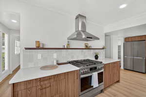 Kitchen with stainless steel appliances, exhaust hood, modern cabinets, recessed lighting, and open shelves