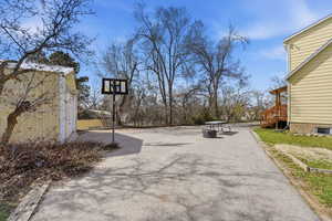 View of patio featuring asphalt driveway