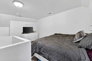 Bedroom with vaulted ceiling