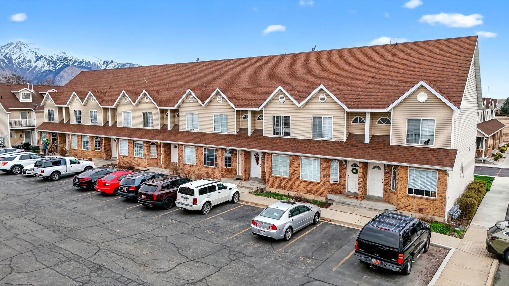 View of building exterior with uncovered parking and a mountain view