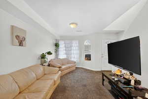 Living area featuring carpet floors and baseboards