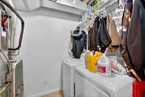 Laundry area featuring heating unit and independent washer and dryer