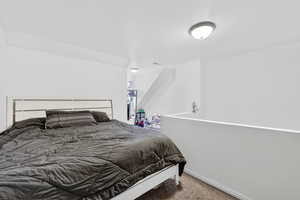 Carpeted bedroom featuring baseboards