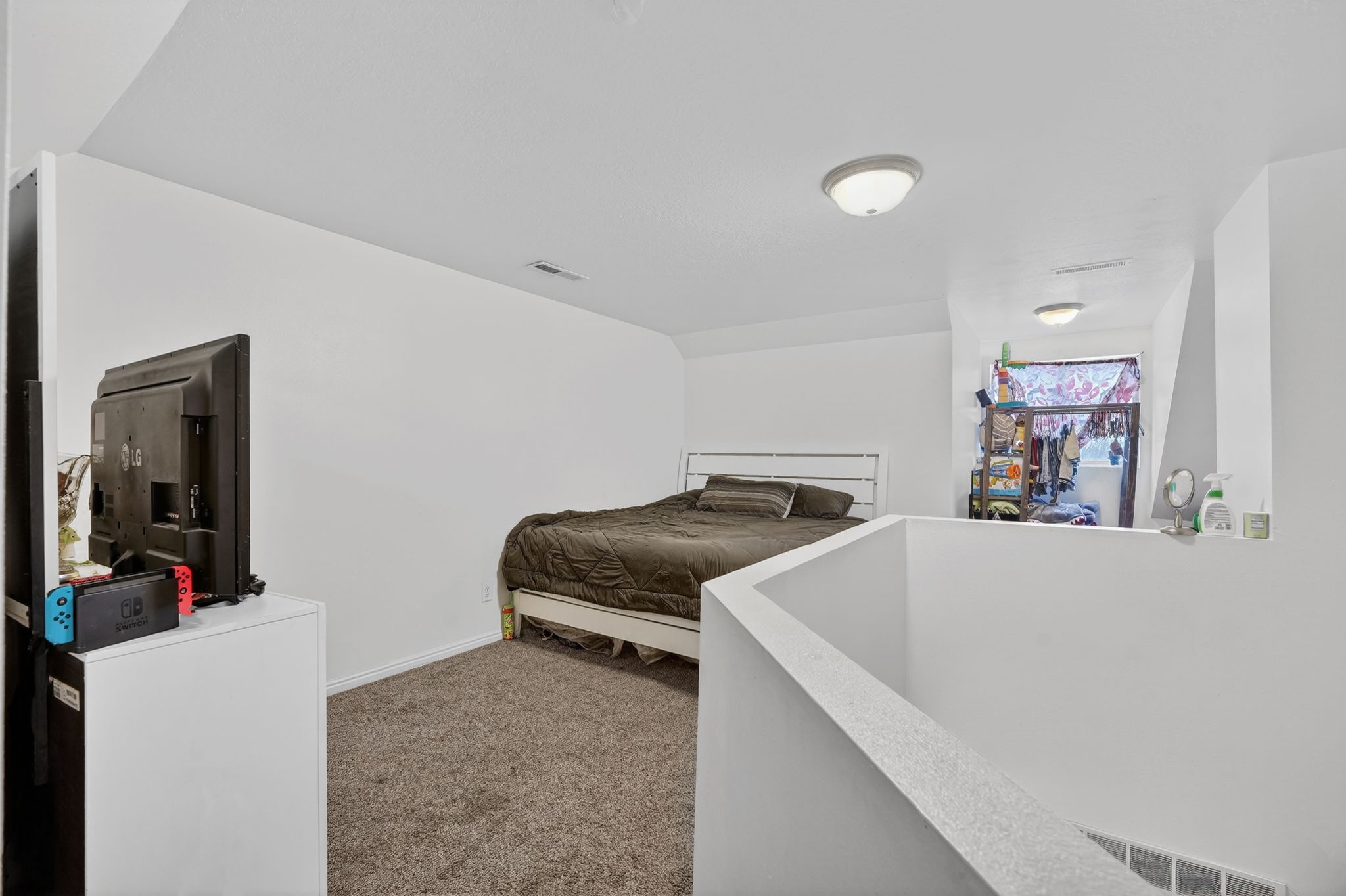 Bedroom with dark carpet and baseboards