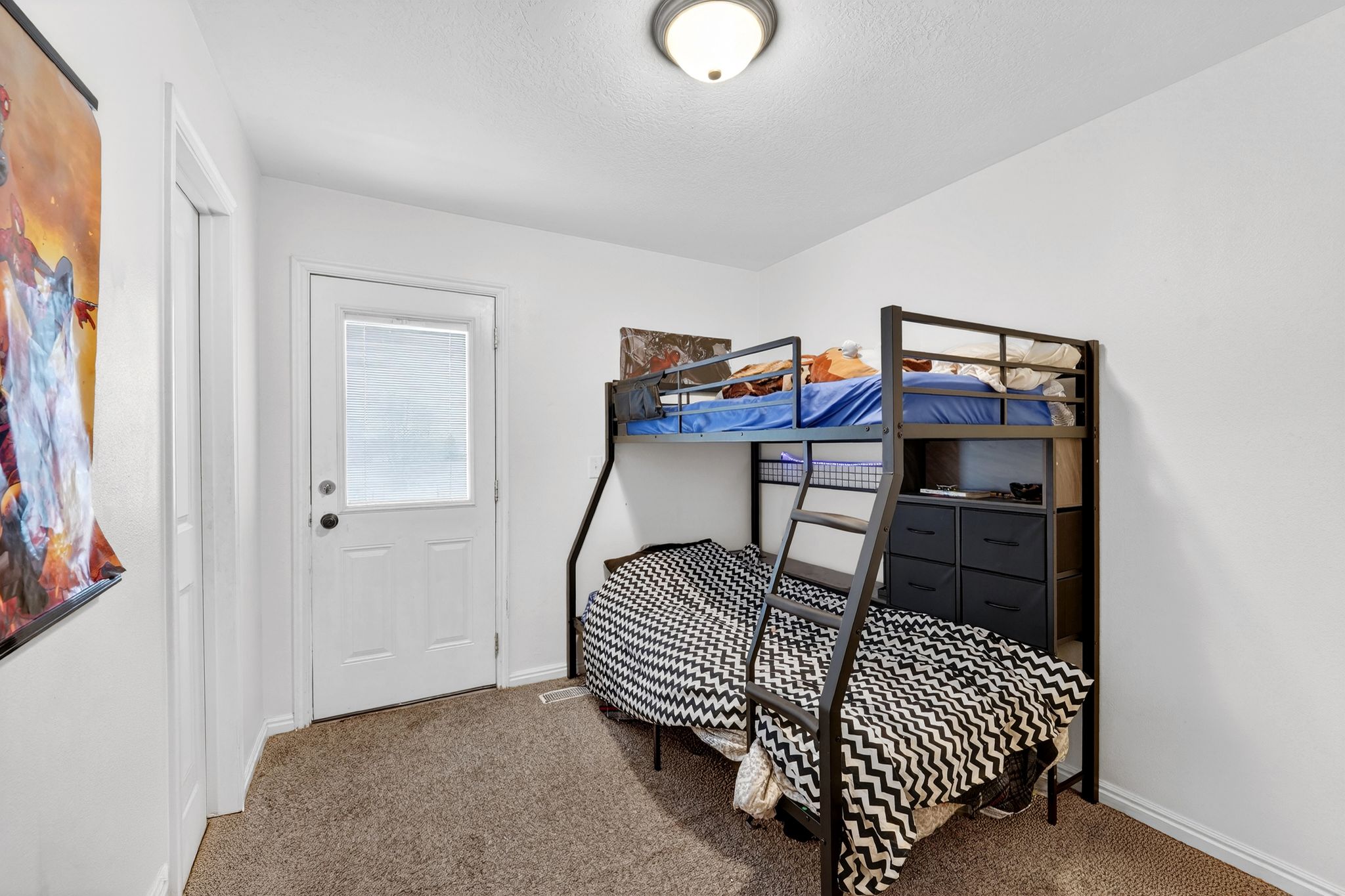 Bedroom featuring carpet and baseboards