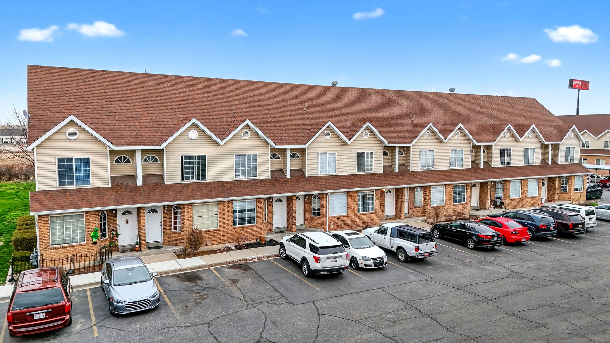 View of property featuring uncovered parking