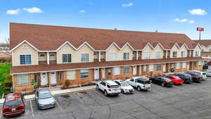 View of property featuring uncovered parking