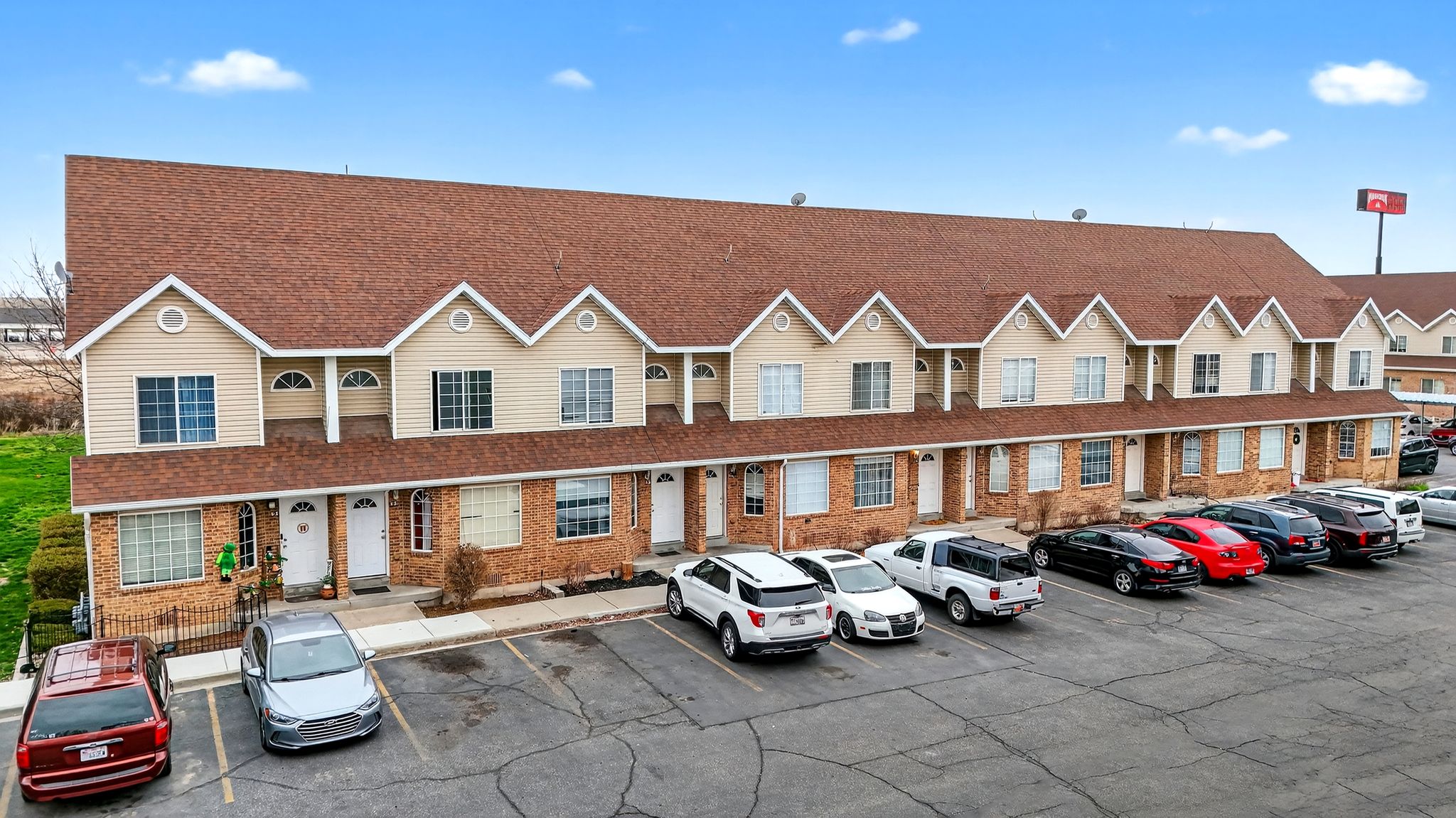 View of property with uncovered parking