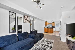 Living area featuring light carpet and light tile patterned flooring