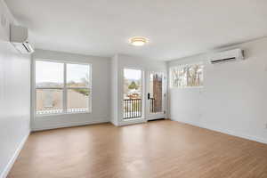 Unfurnished room with light wood-type flooring and a textured ceiling