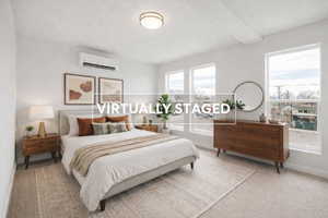 Bedroom featuring a mini split for heating / cooling and light carpet