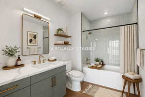 Full bath featuring vanity, shower / bath combo with shower curtain, dark wood-style floors, and recessed lighting