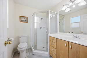 Bathroom featuring vanity, a stall shower, and light tile patterned flooring