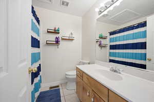 Full bathroom featuring vanity, a shower with curtain, and light tile patterned floors