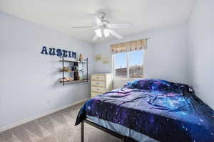 Bedroom with light carpet and a ceiling fan