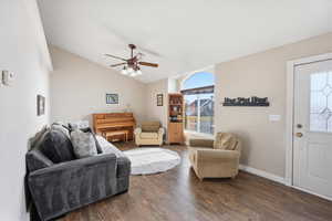 Living area featuring hardwood / wood-style flooring, lofted ceiling, and ceiling fan