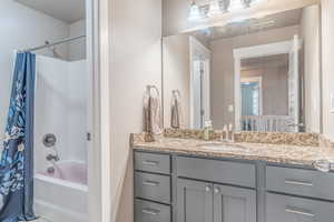 Full bath featuring shower / tub combo with curtain and vanity