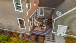 View of exterior entry with a shingled roof