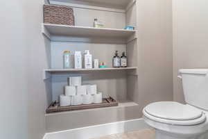 Bathroom featuring toilet and light tile patterned floors