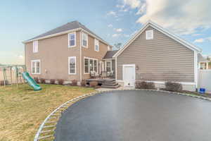 Rear view of property with a playground