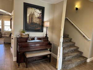 Staircase featuring wood finished floors and baseboards